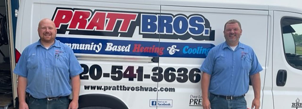 Pratt Brothers standing with their company van